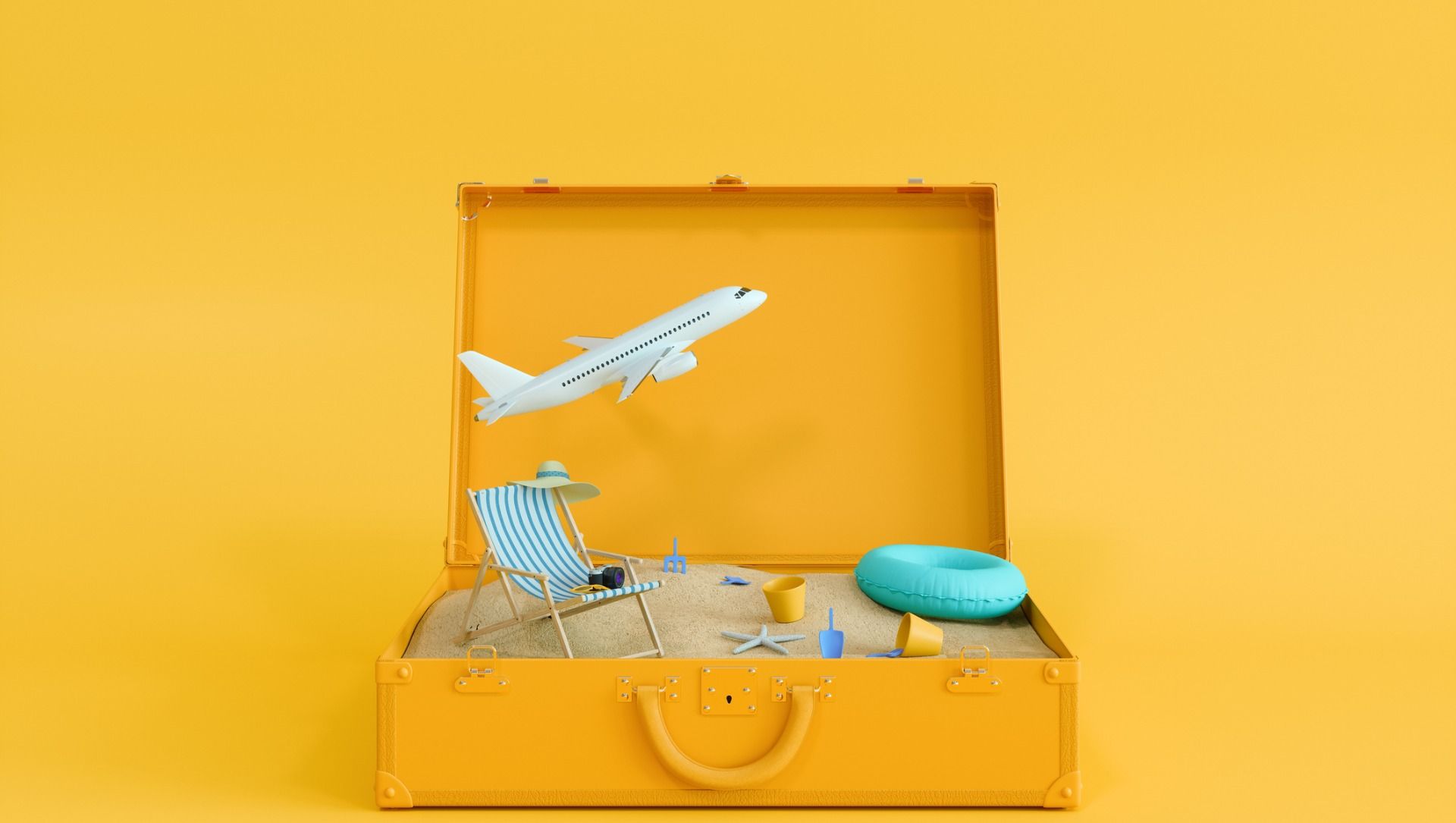 Open suitcase with lounge chair, inflatable floatie and airplane - Cashrewards.jpg