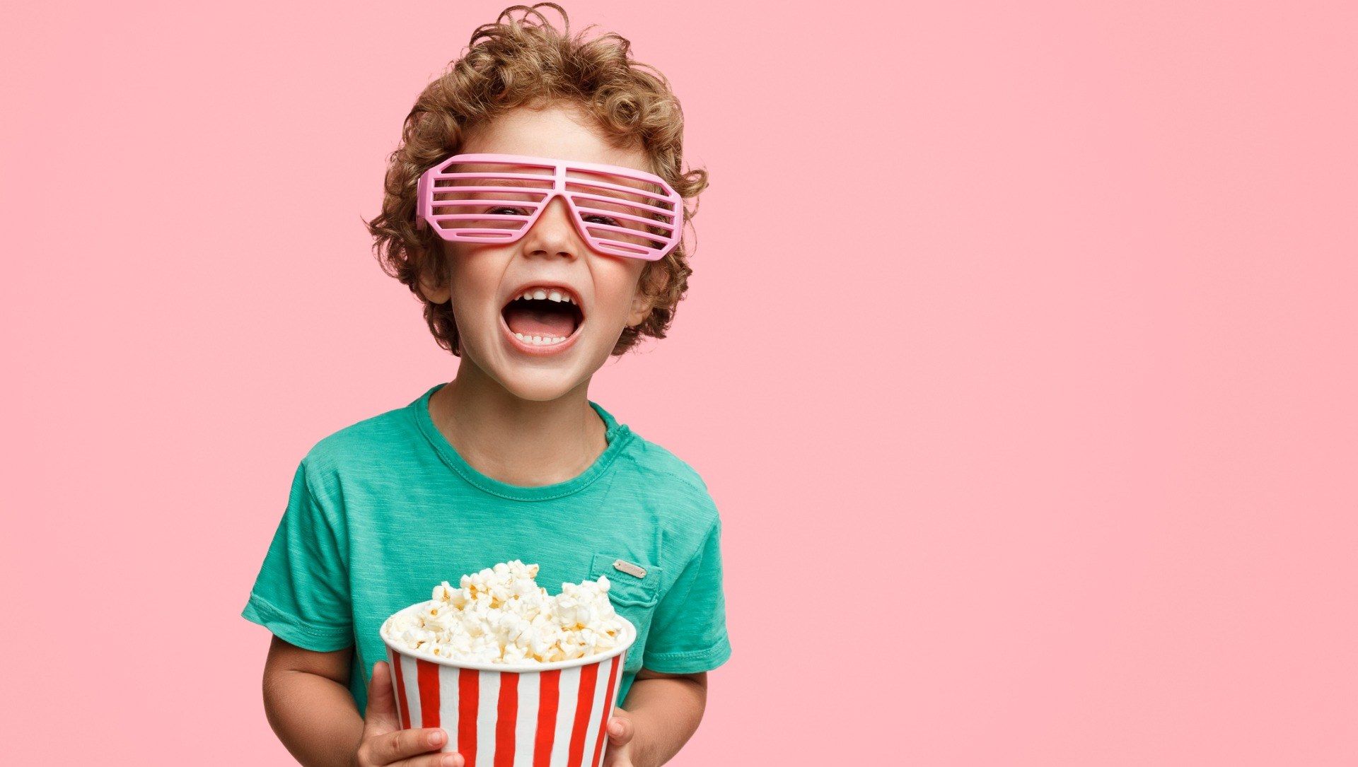 Screaming young boy in glasses holding popcorn - Cashrewards.jpg